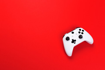 White joystick gamepad, game console isolated on red background. Computer gaming technology play competition videogame control confrontation concept. Cyberspace symbol