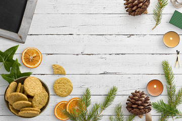 winter decoration with cookies and candles on wooden background