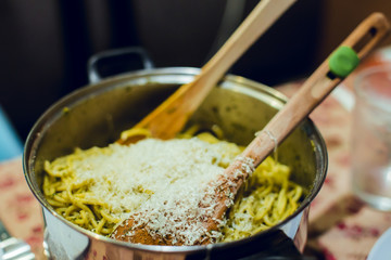Pasta with white pesto in casserole with two spoons