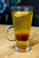 hot tea with lemon and honey in a glass beaker