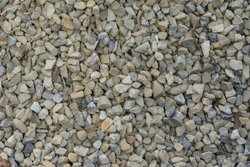 Closeup texture of small and small gray and white stones.