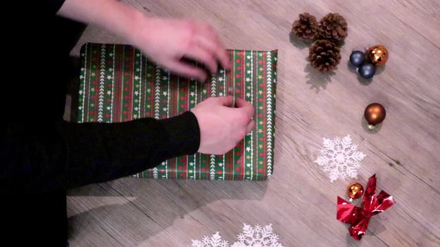 wrapping a gift in Christmas paper 