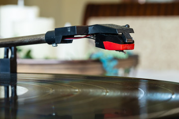 Record needle dropping and playing record on turntable as vinyl record spins bokeh blurry isolated background Nostalgia turntable music 