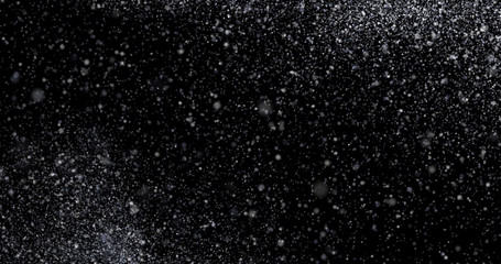 Natural white winter snowfall on a black background