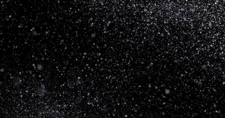 Natural white winter snowfall on a black background