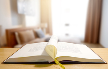 open book on wooden table.