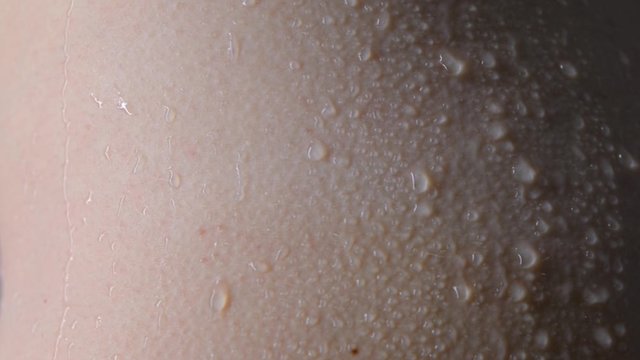 Drops, droplets run down the skin, trickles on wet skin