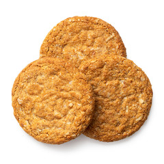 Three crunchy oat and wholemeal biscuits isolated on white. Top view.