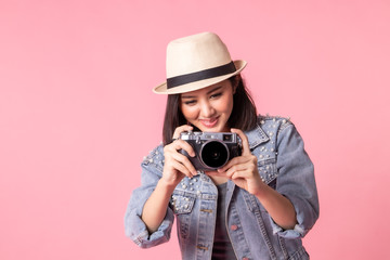 Tourist woman in summer casual clothes.Asian Smiling woman .Passenger traveling abroad to travel on pink background.Asian woman going to summer vacation.Travel trip funny.