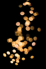 Abstract blurred light sparkles on black bacground.