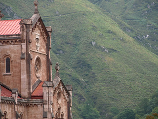 Fototapeta na wymiar Basilica of Covadonga in Asturias with the green mountains in the background