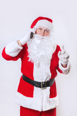 Fototapeta na wymiar Santa Claus calling phone on white background