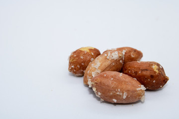  salted peanuts on a white background