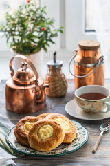 Cheesecake rolls for Breakfast on a wooden table by the window with a cat