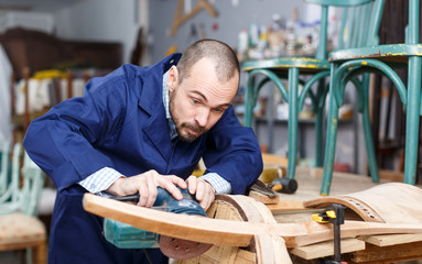 Fototapeta na wymiar Craftsman repairing antique furniture