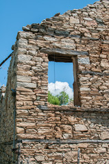 Old destroyed abandoned rural stone house closeup