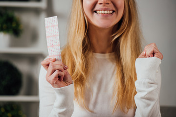 cropped view of woman showing winner gesture while holding lottery ticket - obrazy, fototapety, plakaty