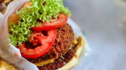 vegan or vegetarian burger with beetroot and sauce and green lettuce and tomato burger closeup
