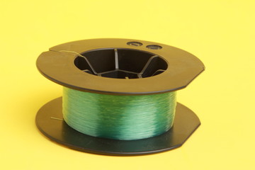 roll of nylon fishing line in color background