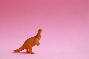 plastic toy with dinosaur shape in color background