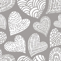 Romantic seamless pattern with cute images of hearts with hand drawn texture. The style of children's drawing.