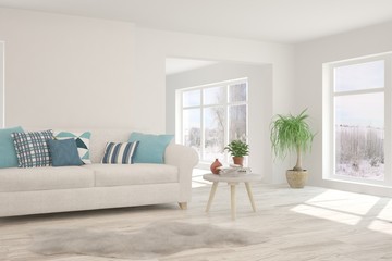 Stylish room in white color with sofa and winter landscape in window. Scandinavian interior design. 3D illustration