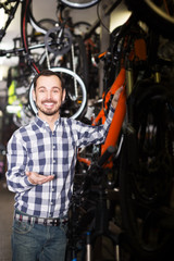 Fototapeta na wymiar Young man in bicycles shop