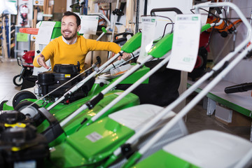 Man choosing lawnmower