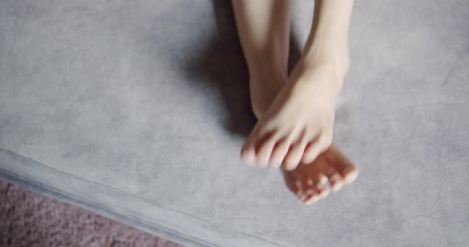 Asian woman scratching on her feet .feeling itchy 