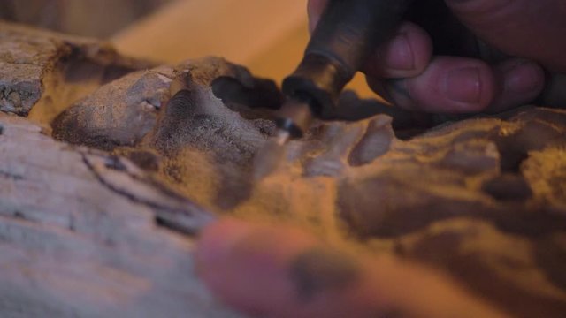 Hands using tool equipment carving wood art warm shed slow motion close up detail