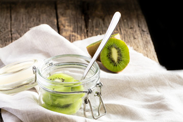 Kiwi in a glass jar on a wooden table.
