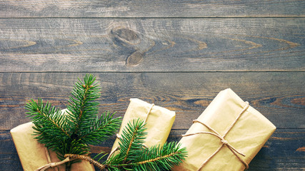 Christmas card. Gift or present boxes on a wooden background, top view with space for text.	