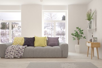 Stylish room in white color with sofa and winter landscape in window. Scandinavian interior design. 3D illustration
