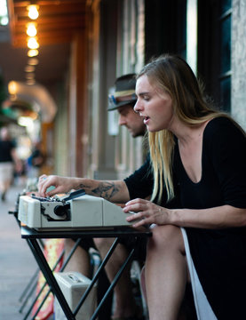 A Young Female Poet Retrieves Paper From Her Vintage Typewriter