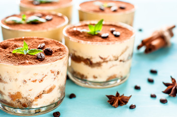 tiramisu in a glass decorated with coffee beans on a dark background