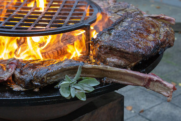 Tomahawk rib steak on hot grill