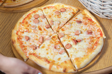 sausage .Pizza slice on wooden tray delicious tasty fast food italian traditional pizza cheese . Pizza on a wooden table.