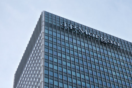London, United Kingdom - February 03, 2019: Sun shines on J P Morgan signage at top of their UK branch at Canary Wharf. JPMorgan Chase is US multinational investment bank founded (originally) 1799