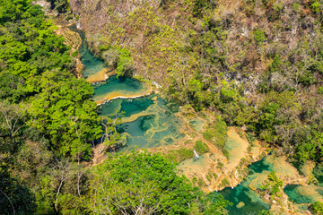 Panorama of the limestone ridge with cascades and waterfalls of Semuc Champey in the Peten jungle and rainforest of Guatemala.