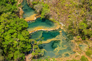 Panorama of the limestone ridge with cascades and waterfalls of Semuc Champey in the Peten jungle and rainforest of Guatemala.