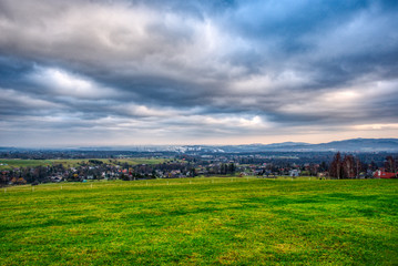 Fototapeta na wymiar industrial valley with beautiful meadow and clouds, Trinec Czech