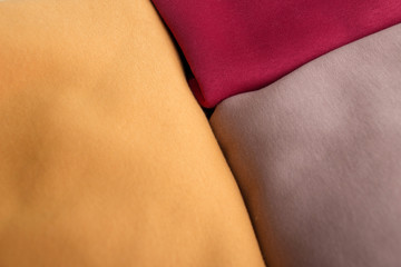 Stack of knitted colorful warm sweaters