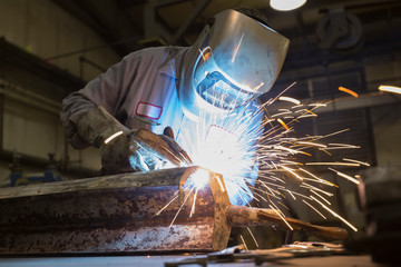 Man welding with sparks flying
