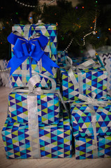  gifts in beautiful packaging with a blue ribbon. Boxes packed in bright paper