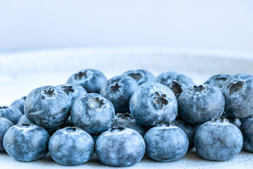 Stack of the fresh blueberries on the table. Close up view. Healthy eating concept.