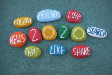 Happy Social 2020 with a creative composition over green sand with carved and multi colored stones