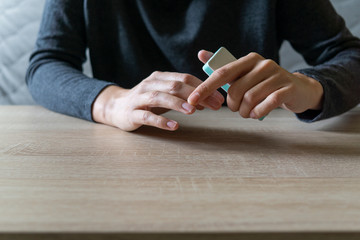 Woman doing the manicure. Removing the polish and putting on the cream. Woman that care his hands. Style concept.