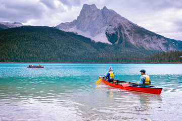 couple canoeing on the lake during winter, Canoeing on Emerald Lake in summer at the Yoho National...
