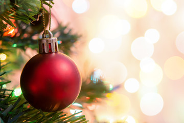 Christmas decoration. Hanging red balls on pine branches Christmas tree garland and ornaments over...