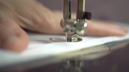 Close up of sewing machine showing process. Item of clothing, vintage style. sewing process in the phase of overstitching. Tailoring Process. Fashion concept. Macro view